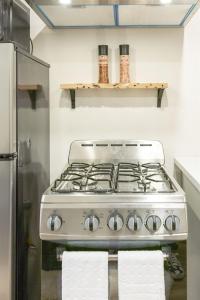 a kitchen with a stove and a refrigerator at 6th Ave district studio Quiet Prkng in Tacoma