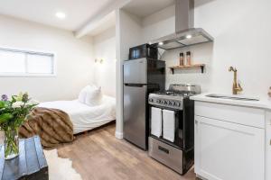 a kitchen with a stove and a bed in a room at 6th Ave district studio Quiet Prkng in Tacoma