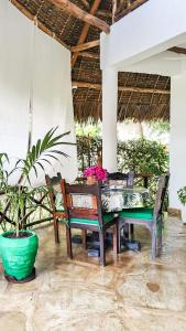 a dining room with a table and chairs at Fasha House Malindi in Malindi