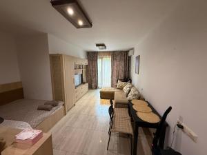 a living room with a couch and a table at Argisht STUDIO 602 in Golden Sands