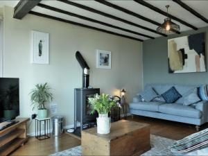 a living room with a couch and a table at Ocean View in Torpoint