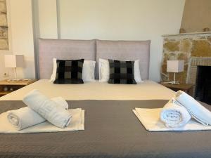 a bedroom with a large bed with two pillows at The Beach House - Apartments & Studios in Afitos