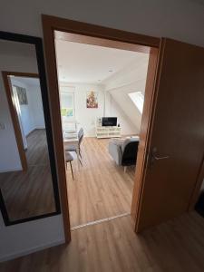 an open door to a room with a living room at StayKassel Apartment in Kassel