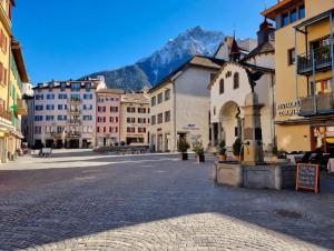 a city street with buildings and a mountain in the background at Cozy Studio in Brig in Gamsen