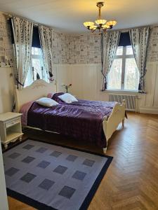 a bedroom with a bed and a chandelier at Furubo in Orkelljunga