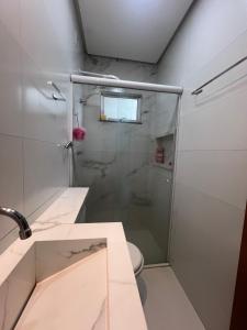 a bathroom with a shower and a sink and a toilet at Casa aconchegante in Imperatriz