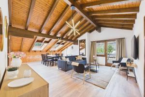 a living room with a blue couch and chairs at Spacious apartment in Brig-Glis in Gamsen