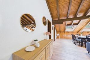a kitchen and dining room with a mirror on the wall at Spacious apartment in Brig-Glis in Gamsen