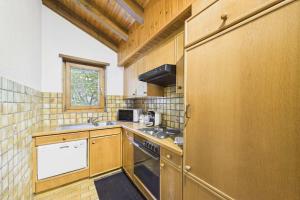 a small kitchen with a stove and a sink at Spacious apartment in Brig-Glis in Gamsen