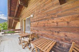 a porch with benches and a wooden wall at Spacious apartment in Brig-Glis in Gamsen