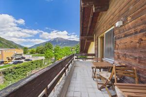 a balcony with a table and chairs on a house at Spacious apartment in Brig-Glis in Gamsen +12 photos