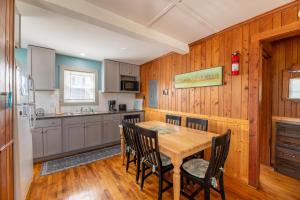 a kitchen with a wooden table and chairs at Bennett's Bungalow - S Nags Head MP 17, 30 Yds to Beach, Year Round Flex Stays in Whalebone