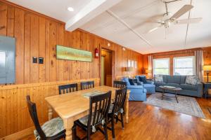 a dining room and living room with a table and chairs at Bennett's Bungalow - S Nags Head MP 17, 30 Yds to Beach, Year Round Flex Stays in Whalebone +20 photos
