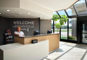 a lobby with a reception desk in a building at Hampton Inn Meridian in Meridian