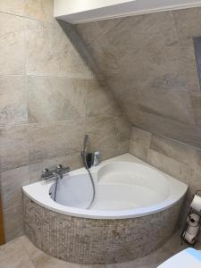 a bathroom with a bath tub in a room at StayKassel Apartment in Kassel +18 photos