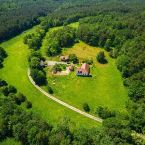 an aerial view of a house on a green field at Pagony Pihenő Farm in Orfalu