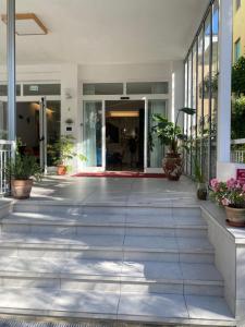 an empty lobby of a building with plants at Hotel St. Moritz in Rimini