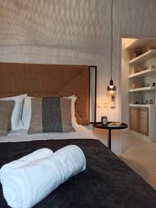 a bedroom with a large bed with a wooden headboard at ÉLYSÉE Boutique in Katavatí