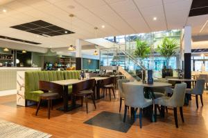 a restaurant with tables and chairs in a building at Hotel Landgoed Zonheuvel in Doorn