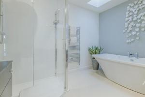 a white bathroom with a tub and a shower at 5 Bed in Hereford oc-78646 in Madley +39 photos