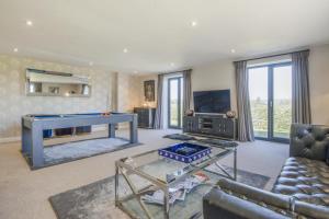 a living room with a pool table and a tv at 5 Bed in Hereford oc-78646 in Madley