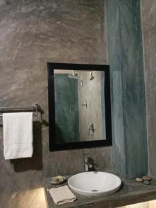 a bathroom with a sink and a mirror at Ayaan Beach Home in Dodanduwa