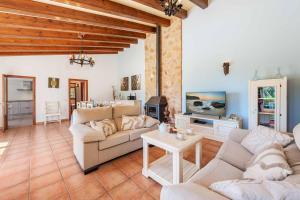 a living room with two couches and a tv at Casa Catalina in Felanitx