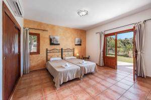 a bedroom with a bed and a large window at Casa Catalina in Felanitx +9 photos