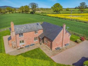 an aerial view of a brick house in a field at 3 Bed in Hereford oc-83659 in Madley