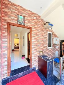 a brick wall in a room with a desk at HARI HARA HOMEs in Rāmeswaram