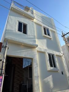 a white building with a window on the side of it at HARI HARA HOMEs in Rāmeswaram