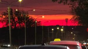 a group of cars parked in a parking lot with a red sky at Sirik hotel in Yerevan