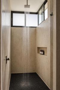 a shower in a bathroom with a shower at Ocean view terrace and saltwater pool group getaway in Todos Santos