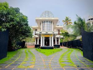 a building with a walkway in front of it at Kings Castle in Varkala