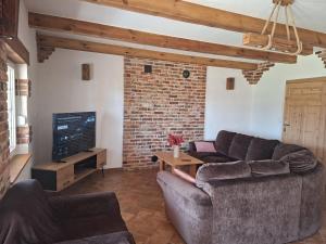 a living room with two couches and a tv at Mazury Villa Ecomfort in Szeligi +15 photos