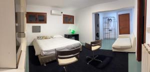 a bedroom with a bed and two chairs in it at Park House in Mondello