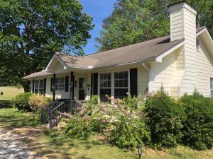 a small white house with a porch at Beautiful Farmhouse near Atlanta's Airport! in Atlanta