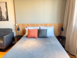 a bed with two pillows on it in a room at Studio equipado com Piscina espaço histórico. in Rio de Janeiro +32 photos