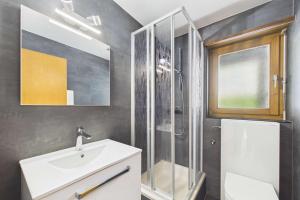 a bathroom with a sink and a shower at Cozy Studio with a Garden in Gamsen
