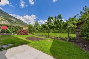 a garden with a playground and a swing at Cozy Studio with a Garden in Gamsen
