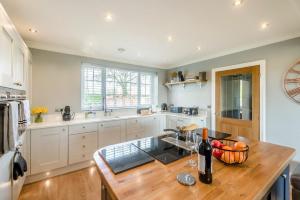 a kitchen with white cabinets and a wooden counter top at 3 Bed in Ebberston oc-s35053 in Ebberston