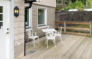 a patio with a table and chairs on a deck at Beautiful Apartment In Höör in Höör