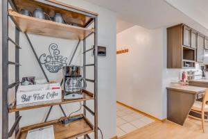 a kitchen with a counter and a shelf at The KANtucky Derby Home in Derby