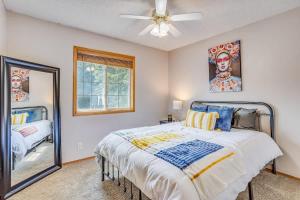 a bedroom with a bed and a mirror at The KANtucky Derby Home in Derby