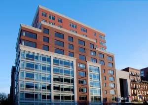 a tall brick building with many windows at Aloft by Marriott Harlem in New York