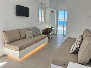 a living room with a couch and a table at Daphne in Naousa
