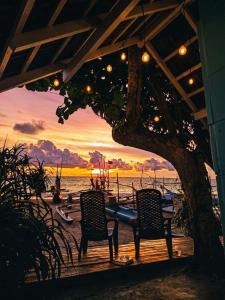 two chairs sitting under a pavilion with a view of the ocean at Ayaan Beach Home in Dodanduwa