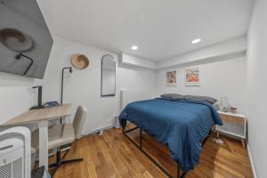a bedroom with a bed and a desk and a table at Double Room with shared bathroom in Times Square in New York