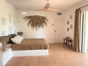 a bedroom with a bed and a ceiling fan at Finca LA SELVA, Exclusive Villa in Benimussa in San Antonio +53 photos