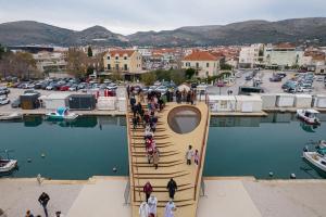 a group of people walking on a wooden bridge over a marina at Luxury rooms il Ponte Trogir II in Trogir +11 photos